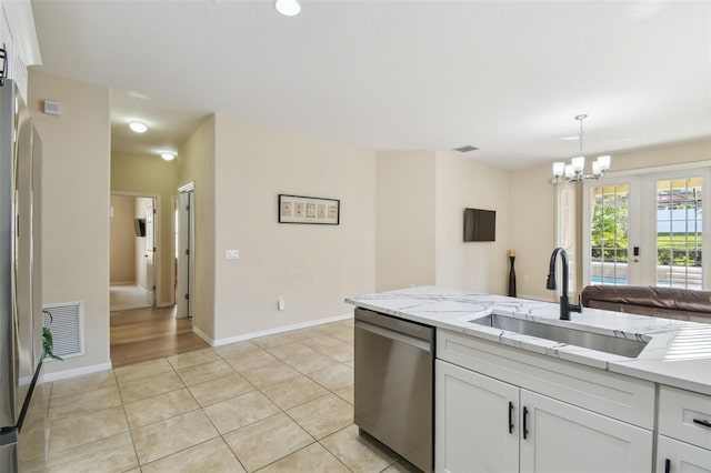 kitchen with white cabinetry, sink, light stone counters, and stainless steel appliances