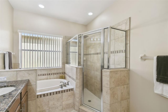 bathroom with vanity and shower with separate bathtub