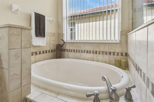 bathroom featuring a bathtub and a wealth of natural light