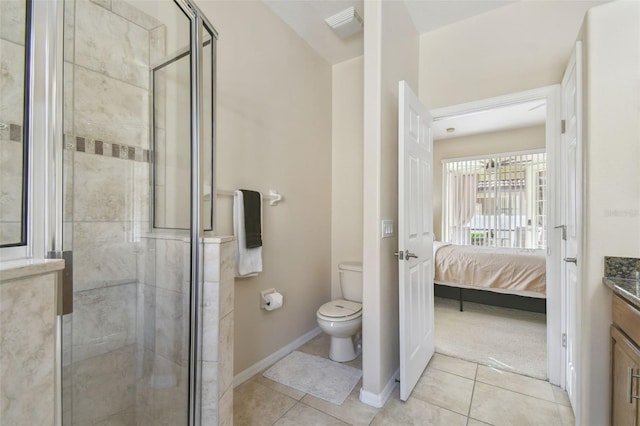 bathroom featuring vanity, a shower with shower door, tile patterned floors, and toilet