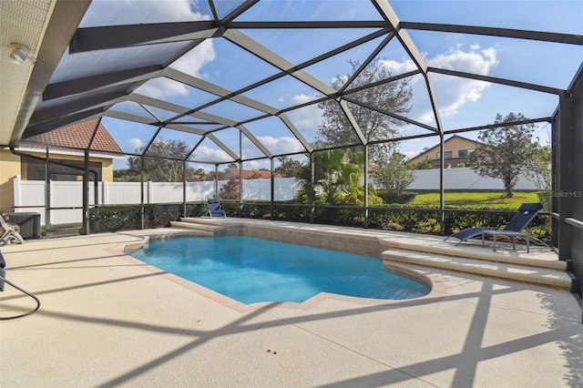 view of pool with a patio area and glass enclosure