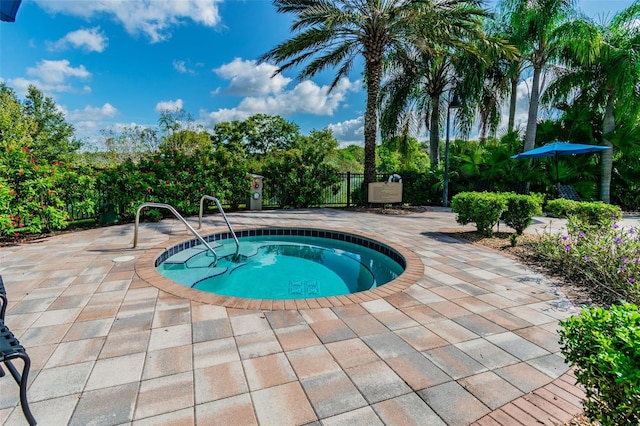 view of swimming pool with a patio area and an in ground hot tub