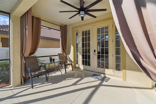 sunroom featuring ceiling fan and french doors