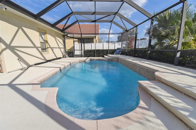 view of swimming pool featuring a lanai