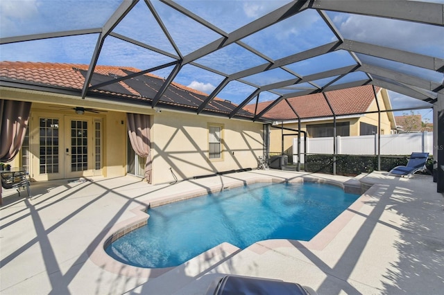 view of pool featuring french doors, a patio area, and glass enclosure