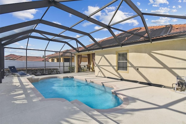 view of swimming pool featuring a lanai and a patio area