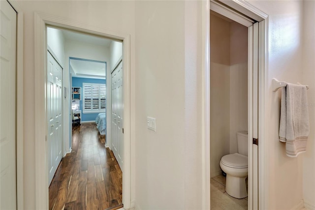 hallway with dark hardwood / wood-style flooring