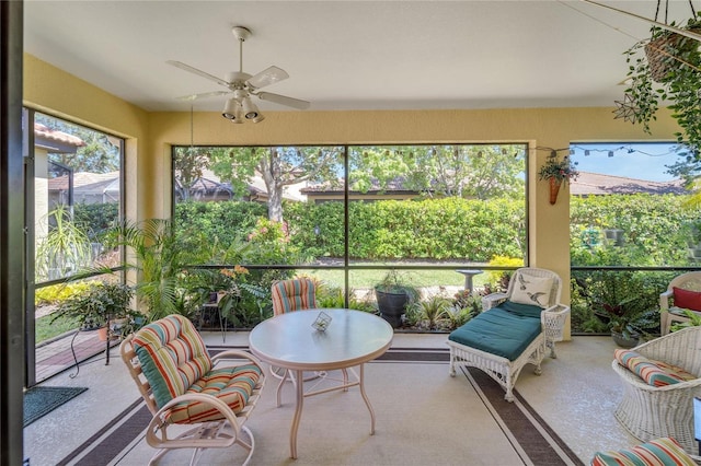 sunroom / solarium featuring ceiling fan