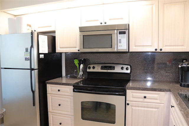 kitchen with tasteful backsplash, white cabinetry, and stainless steel appliances