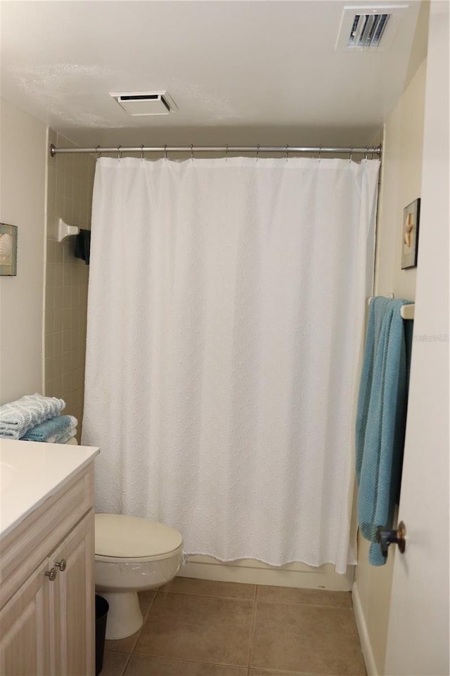 full bathroom featuring tile patterned floors, toilet, vanity, and shower / bath combo