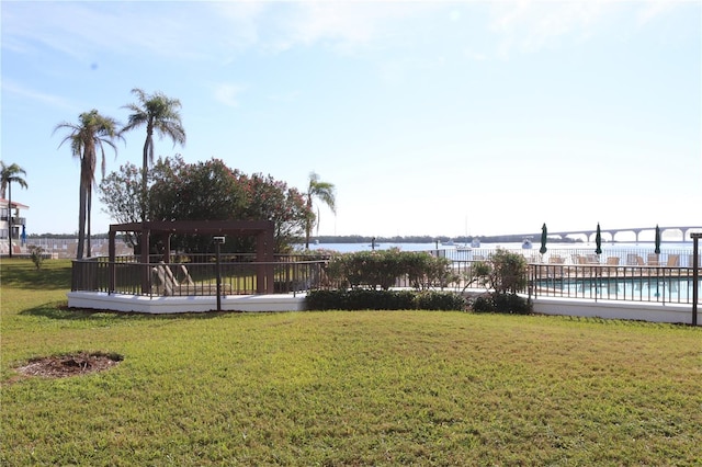 view of yard with a community pool, a pergola, and a water view