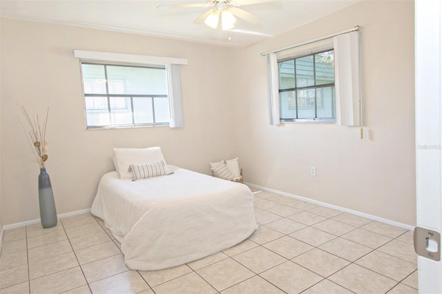 tiled bedroom featuring ceiling fan