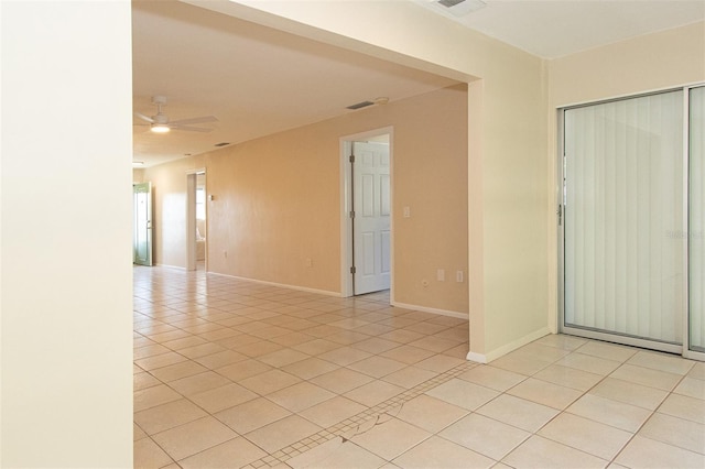 spare room featuring ceiling fan and light tile patterned floors