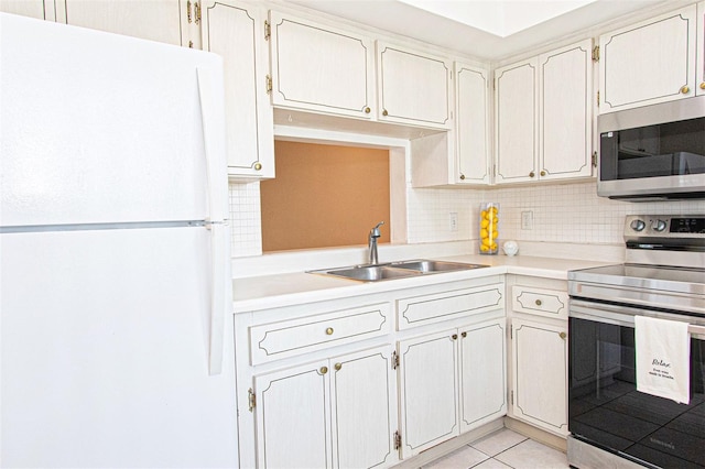 kitchen featuring stainless steel appliances, tasteful backsplash, sink, and light tile patterned flooring