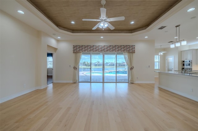 unfurnished living room with wooden ceiling, a raised ceiling, and light wood finished floors