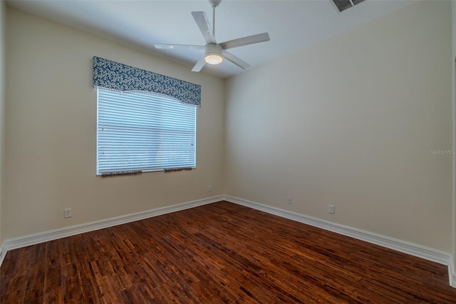 unfurnished room featuring dark wood-style floors, a ceiling fan, and baseboards