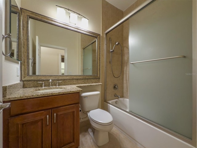 bathroom featuring tile patterned flooring, shower / bath combination with glass door, vanity, and toilet