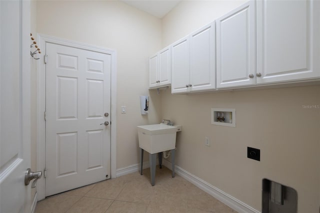 clothes washing area with washer hookup, light tile patterned floors, cabinet space, hookup for an electric dryer, and baseboards