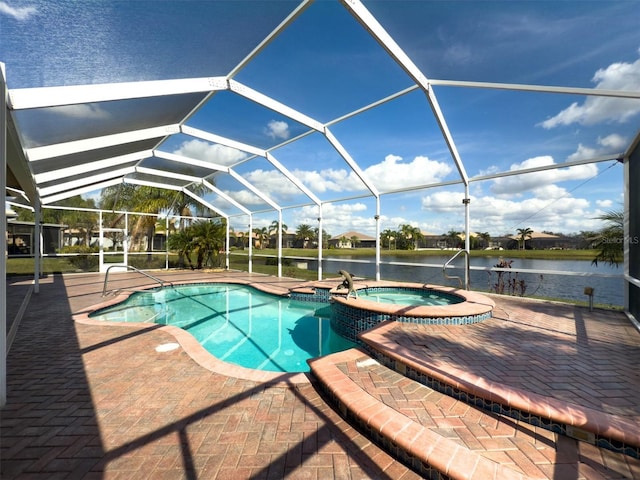 view of pool with a lanai, a patio area, a pool with connected hot tub, and a water view