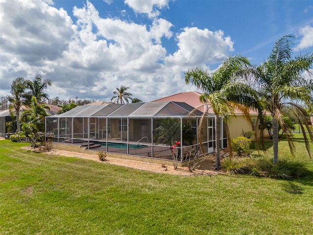 exterior space with glass enclosure and a yard