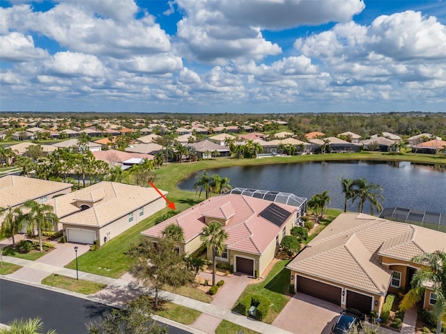 birds eye view of property featuring a water view and a residential view