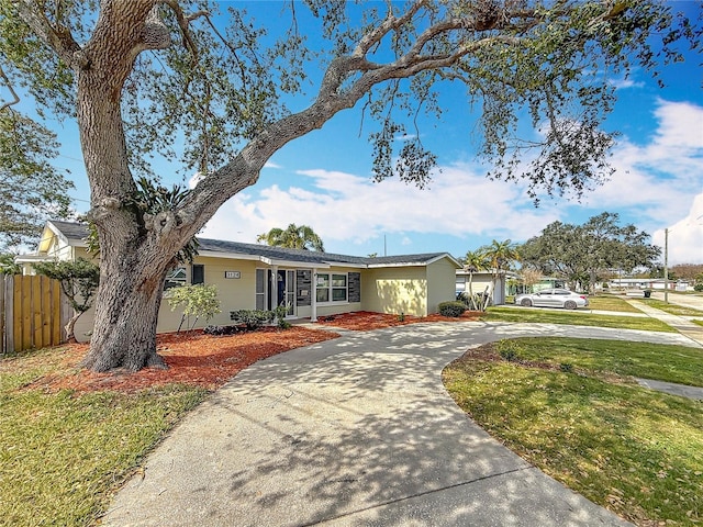 ranch-style home featuring a front yard