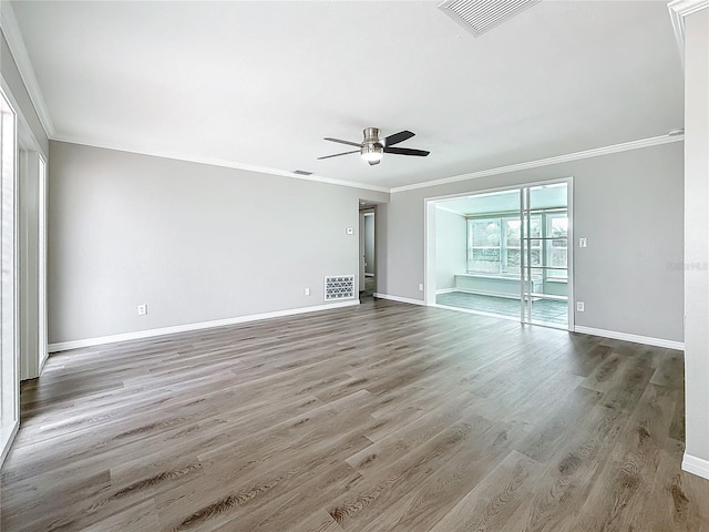 empty room with hardwood / wood-style flooring, ceiling fan, and ornamental molding