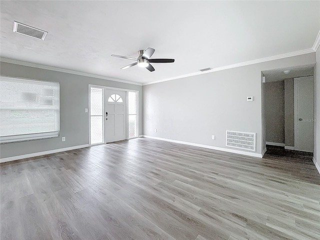 unfurnished living room featuring ornamental molding, ceiling fan, and light hardwood / wood-style flooring