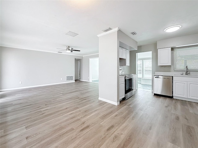 kitchen featuring appliances with stainless steel finishes, sink, white cabinets, and light hardwood / wood-style flooring