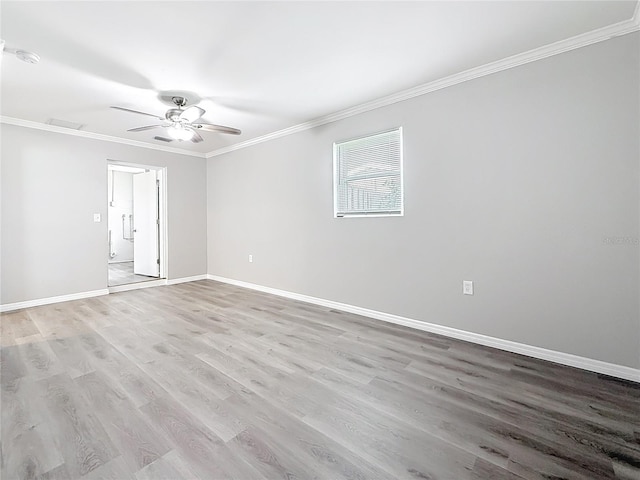 spare room featuring ornamental molding, ceiling fan, and light wood-type flooring