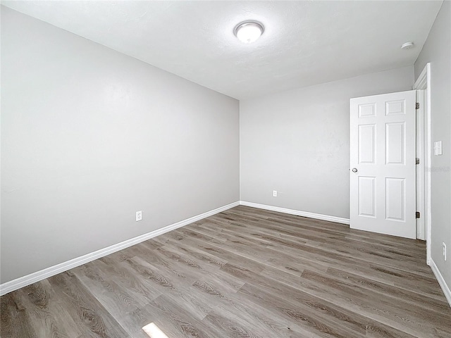 empty room featuring wood-type flooring