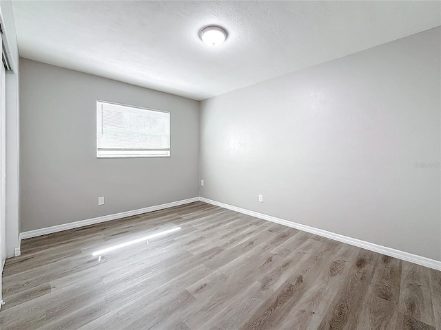 unfurnished room with light hardwood / wood-style floors