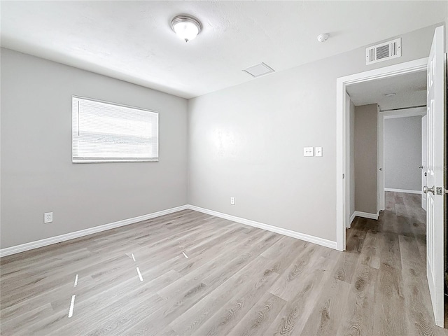 spare room featuring light wood-type flooring