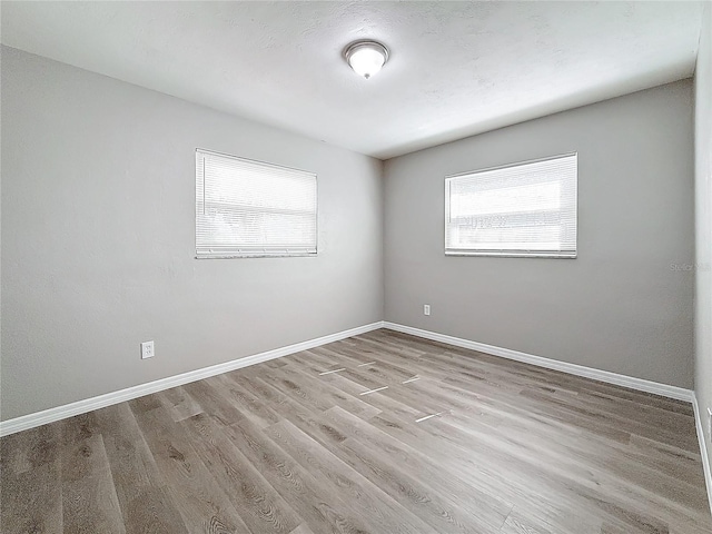 unfurnished room with light hardwood / wood-style floors