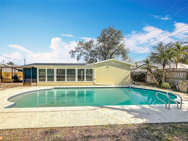 view of pool featuring a sunroom