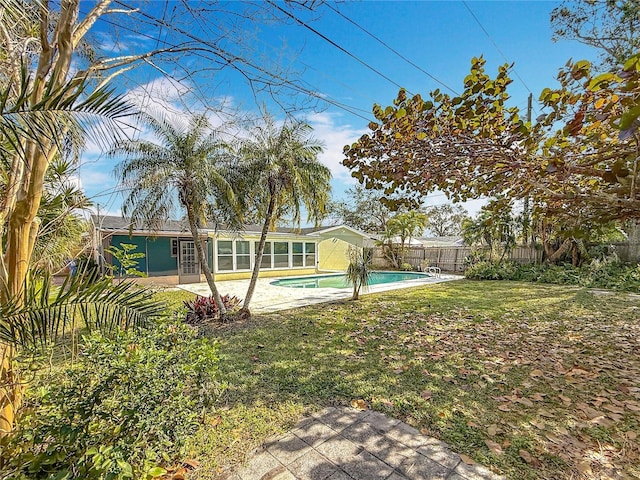 view of yard with a fenced in pool and a patio area