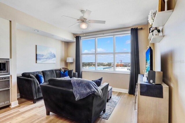 living room with ceiling fan and light hardwood / wood-style floors