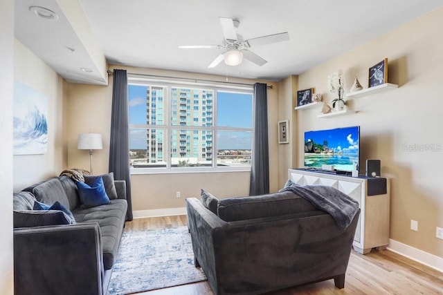 living room with ceiling fan and light wood-type flooring