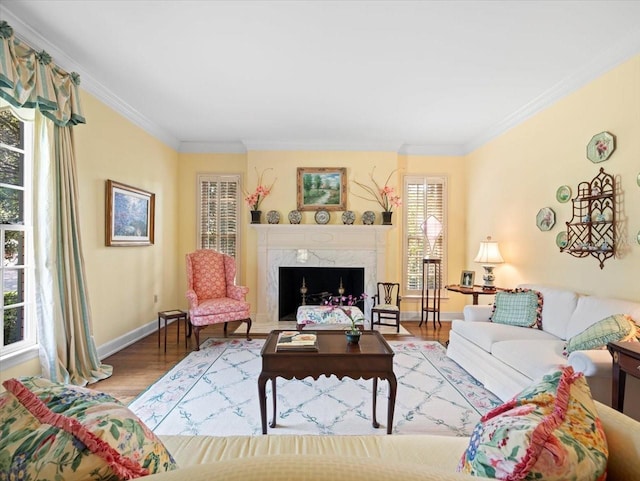 living room with crown molding, wood-type flooring, and a high end fireplace