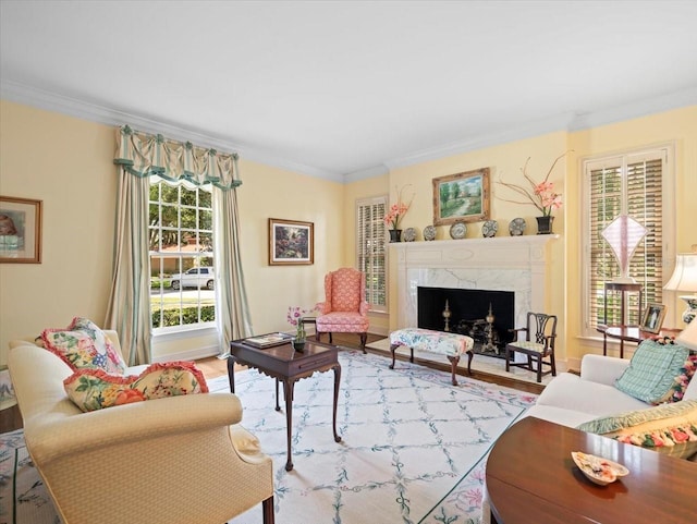 living room featuring ornamental molding, plenty of natural light, and light hardwood / wood-style floors