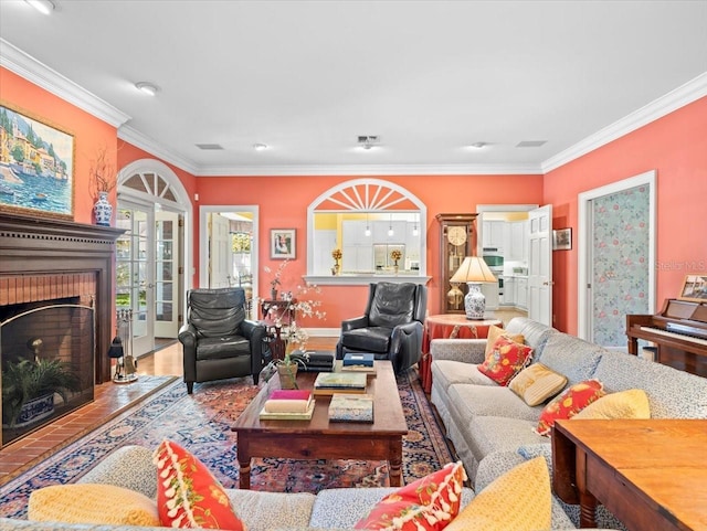 living room featuring hardwood / wood-style flooring, ornamental molding, a fireplace, and french doors