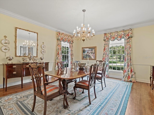 dining area with a notable chandelier, crown molding, and wood-type flooring