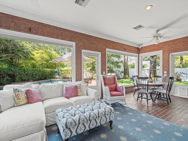 sunroom featuring ceiling fan