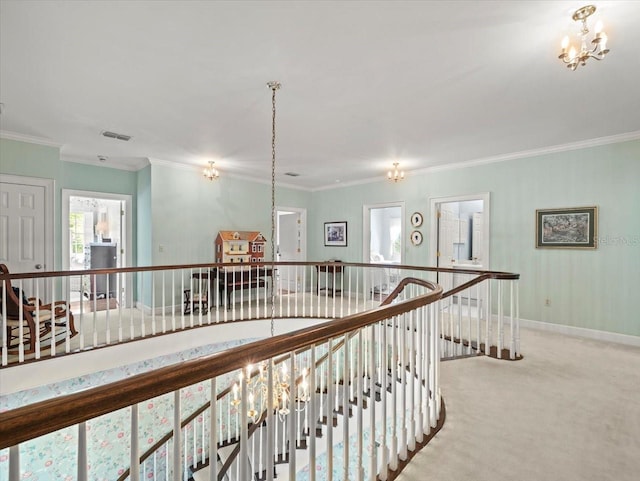 hall featuring crown molding, light colored carpet, and a chandelier