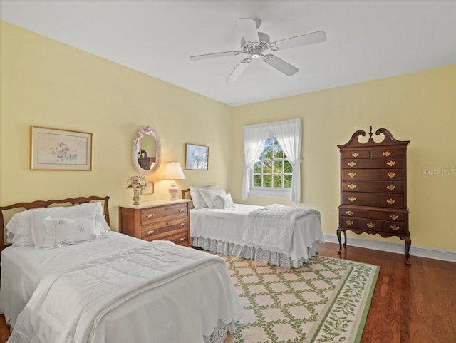 bedroom with ceiling fan and dark hardwood / wood-style flooring