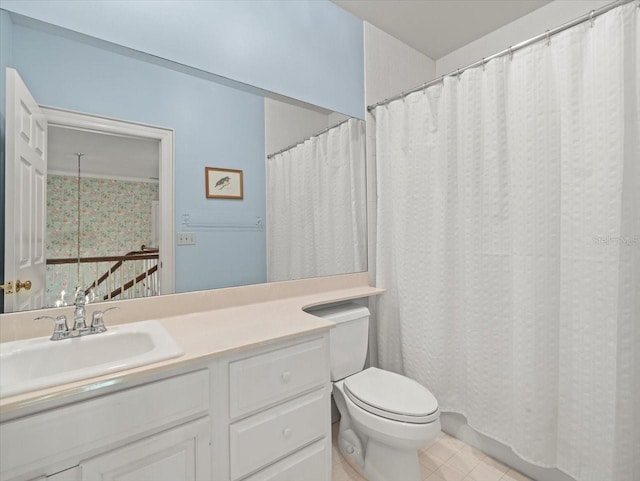 bathroom with vanity, tile patterned flooring, toilet, and walk in shower