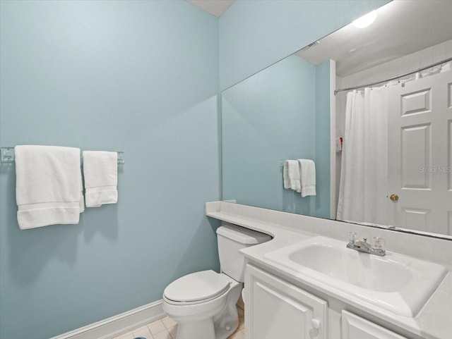 bathroom featuring vanity, a shower with shower curtain, tile patterned floors, and toilet