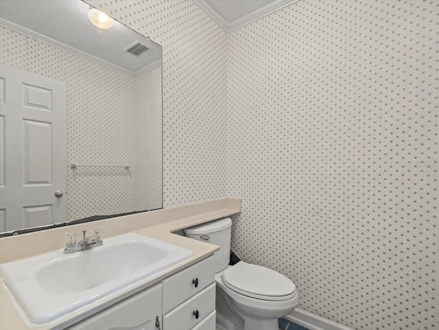 bathroom featuring ornamental molding, toilet, and vanity