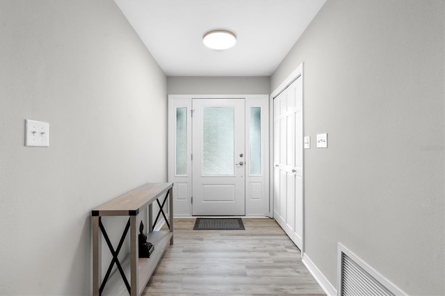 doorway to outside with light wood-type flooring