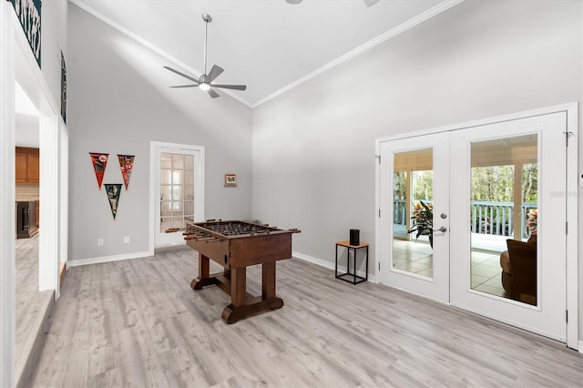 playroom featuring ornamental molding, light hardwood / wood-style flooring, high vaulted ceiling, and french doors